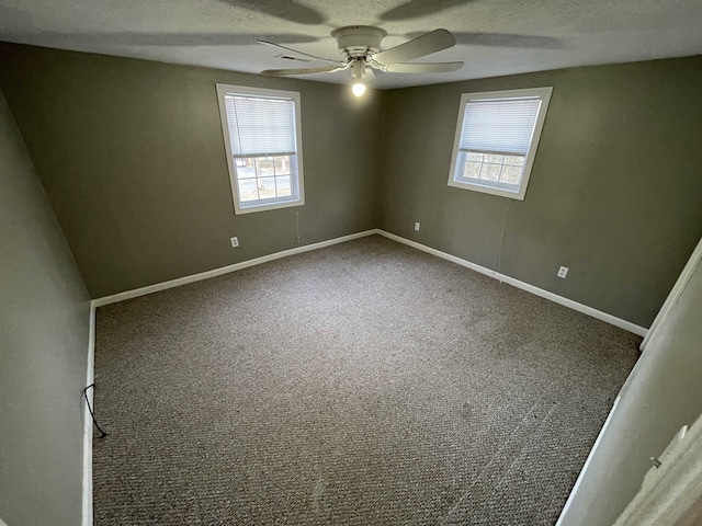 spare room with a textured ceiling, ceiling fan, carpet, and plenty of natural light