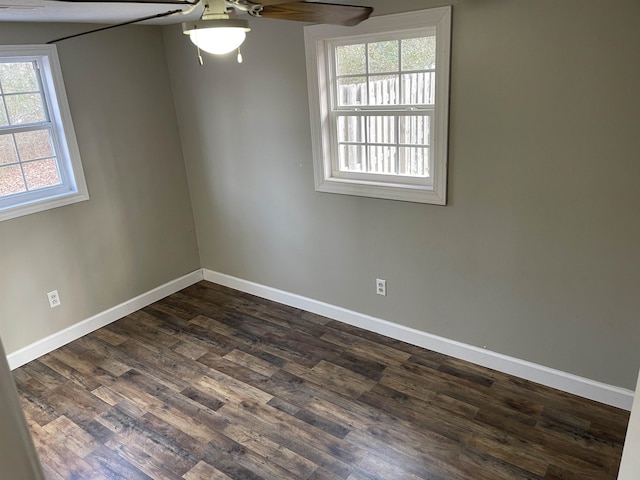 unfurnished room featuring dark hardwood / wood-style floors, plenty of natural light, and ceiling fan