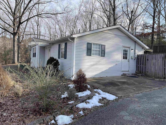 snow covered property featuring a patio