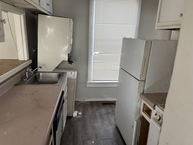 kitchen featuring dark hardwood / wood-style flooring, dishwasher, white refrigerator, white cabinets, and sink