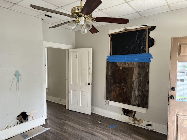 unfurnished living room featuring a paneled ceiling, dark hardwood / wood-style flooring, and ceiling fan