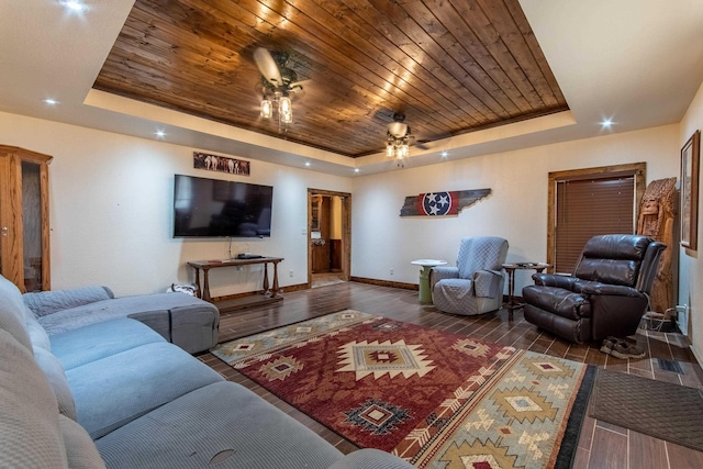 living room featuring ceiling fan, wood ceiling, and a raised ceiling