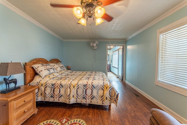 bedroom with ceiling fan, dark wood-type flooring, a textured ceiling, and crown molding