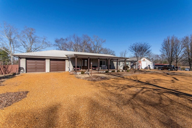 ranch-style home with a garage and a porch