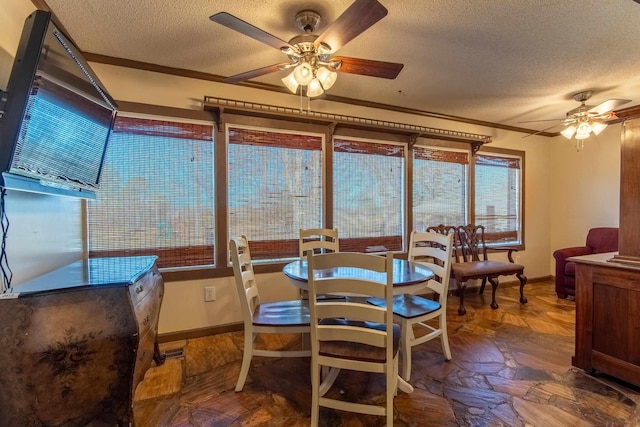 dining room with a textured ceiling, ceiling fan, and crown molding