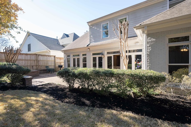 rear view of house featuring a patio area and a yard