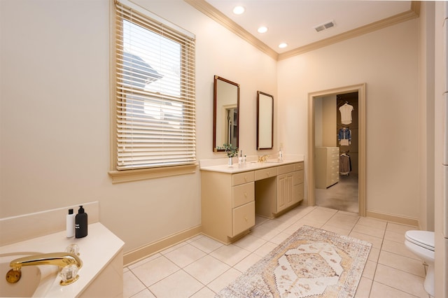 bathroom with tile patterned floors, vanity, toilet, a bath, and crown molding