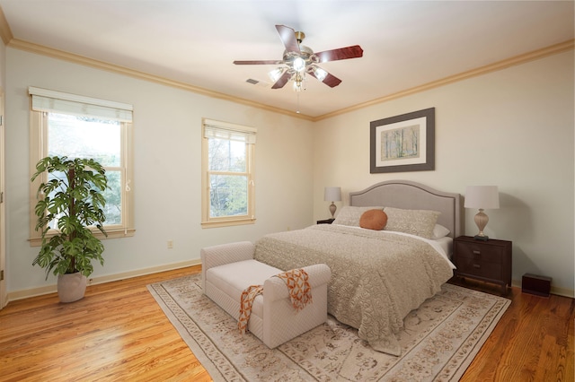 bedroom with ceiling fan, wood-type flooring, and crown molding