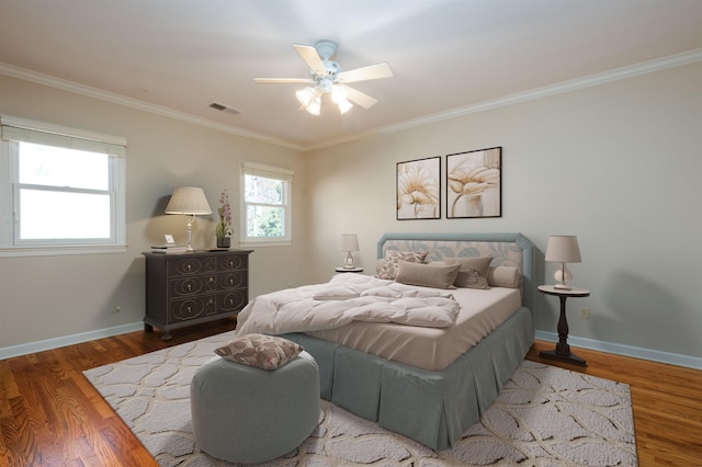 bedroom with ceiling fan, ornamental molding, and hardwood / wood-style floors