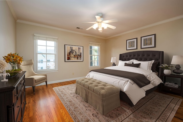 bedroom featuring ceiling fan, ornamental molding, and hardwood / wood-style floors