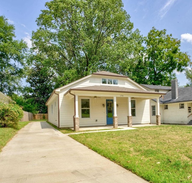 view of front of property with covered porch and a front yard