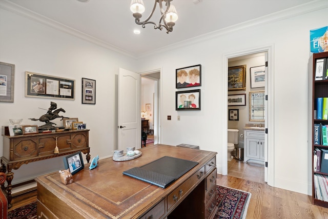 office area featuring light wood-type flooring, an inviting chandelier, and crown molding