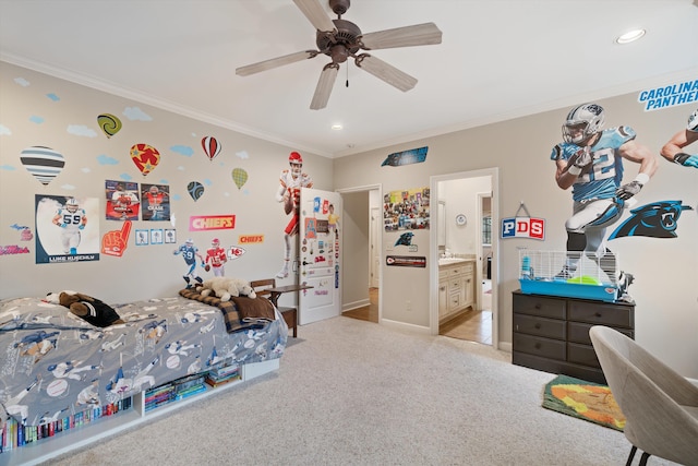 carpeted bedroom with ceiling fan, ornamental molding, and ensuite bath