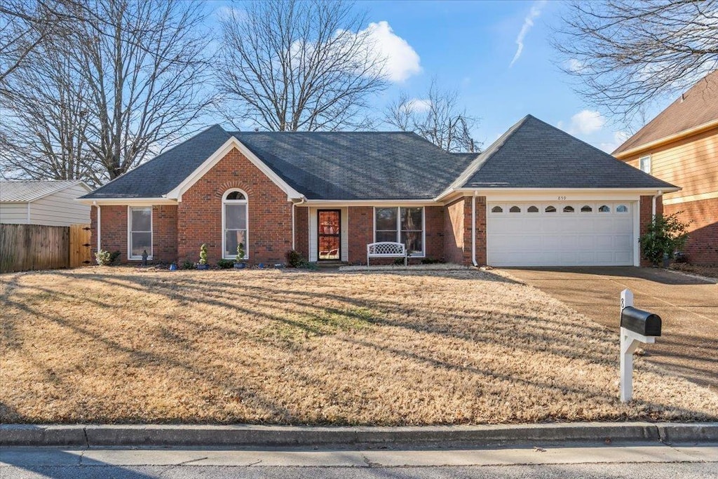 view of front of home with a front lawn and a garage