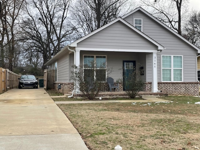 bungalow-style house with a front yard and a porch