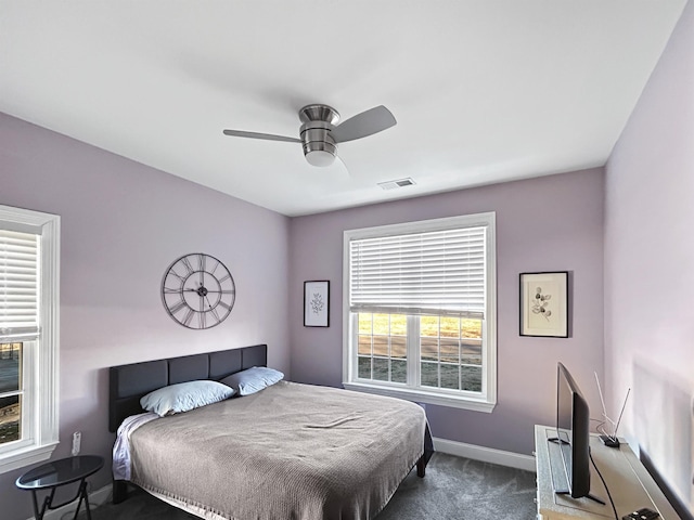 bedroom with ceiling fan and dark carpet