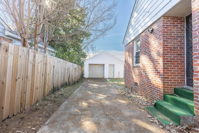 view of property exterior featuring a garage and an outbuilding