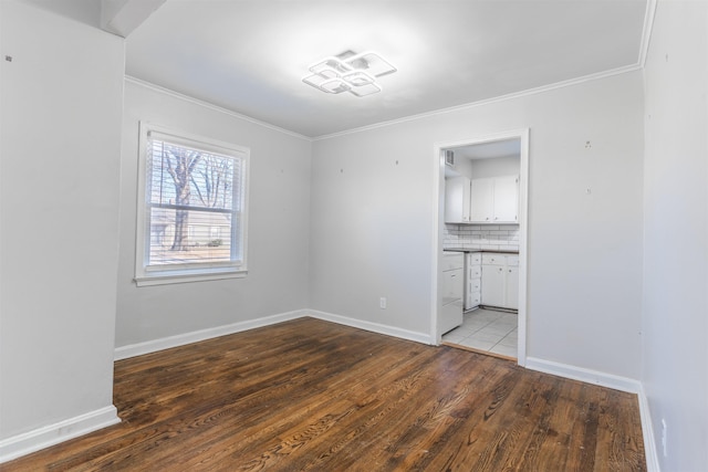 empty room with light wood-type flooring and crown molding