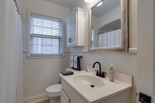 bathroom featuring toilet and vanity