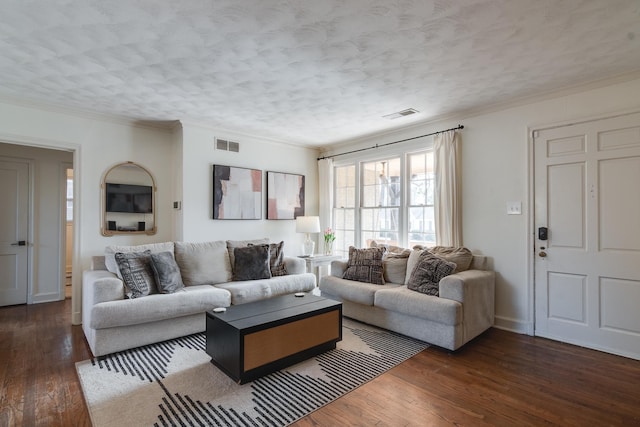 living room featuring a textured ceiling, dark hardwood / wood-style flooring, and ornamental molding