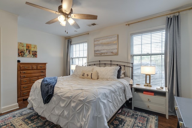 bedroom featuring ceiling fan, dark hardwood / wood-style floors, and ornamental molding