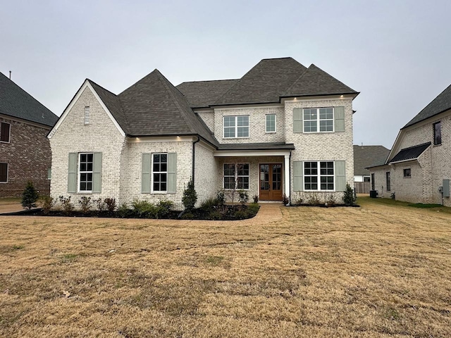 french provincial home with a front lawn