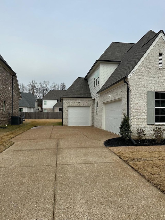 view of home's exterior featuring a garage and central air condition unit