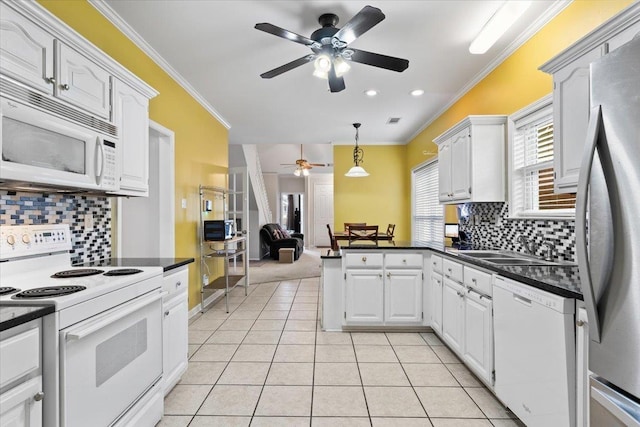 kitchen featuring white cabinetry, pendant lighting, tasteful backsplash, and white appliances