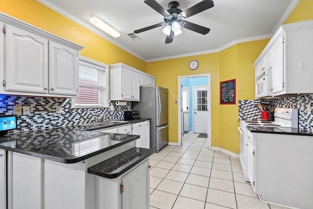 kitchen featuring kitchen peninsula, light tile patterned flooring, crown molding, white appliances, and white cabinetry