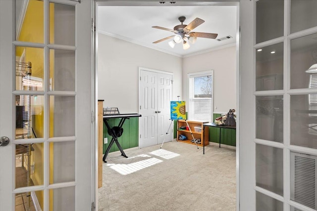 carpeted home office with ceiling fan and crown molding