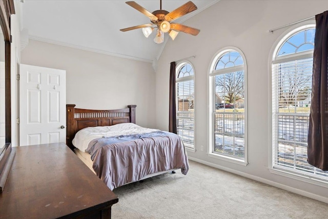 bedroom with vaulted ceiling, ceiling fan, carpet, and ornamental molding