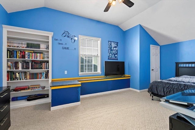 carpeted bedroom with vaulted ceiling and ceiling fan