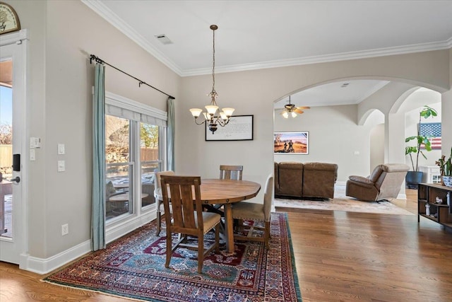 dining space featuring crown molding, ceiling fan with notable chandelier, and hardwood / wood-style flooring