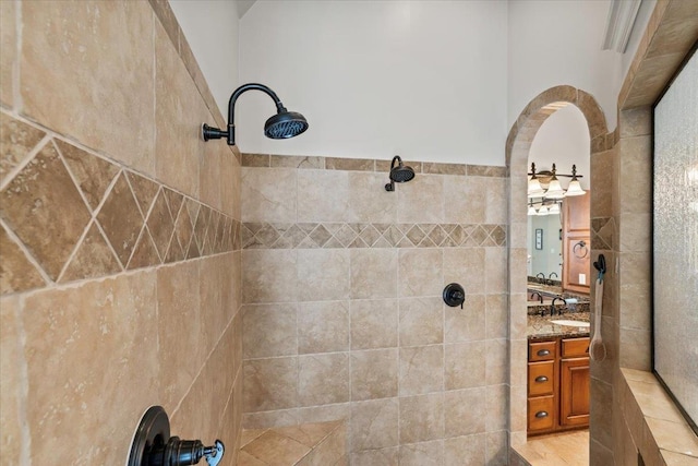 bathroom featuring tile walls, walk in shower, and vanity