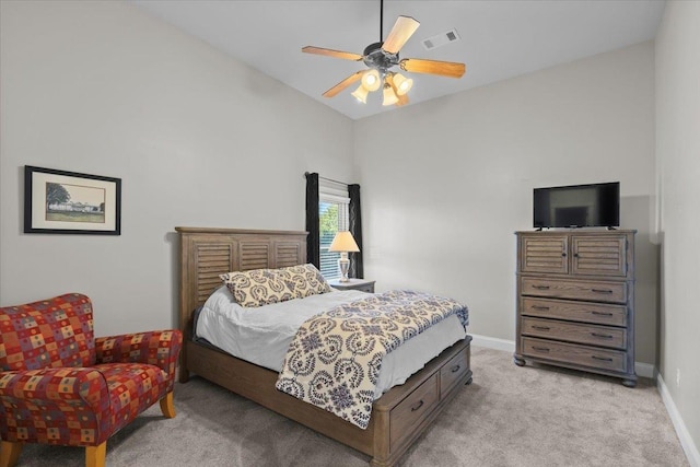 carpeted bedroom with ceiling fan and vaulted ceiling