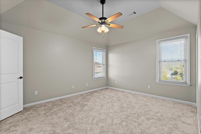 carpeted spare room featuring ceiling fan and vaulted ceiling