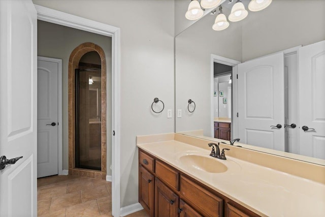 bathroom featuring walk in shower and vanity