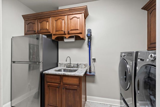 laundry room with independent washer and dryer and sink