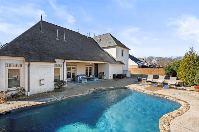 view of swimming pool with grilling area, a patio area, and an outdoor hangout area