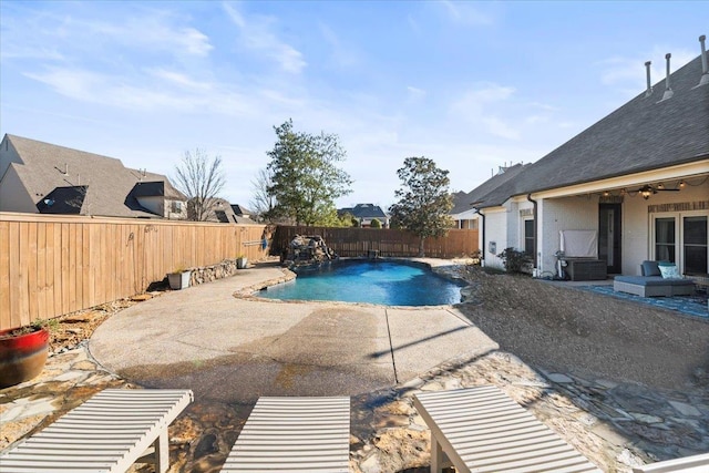 view of pool with ceiling fan, pool water feature, and a patio