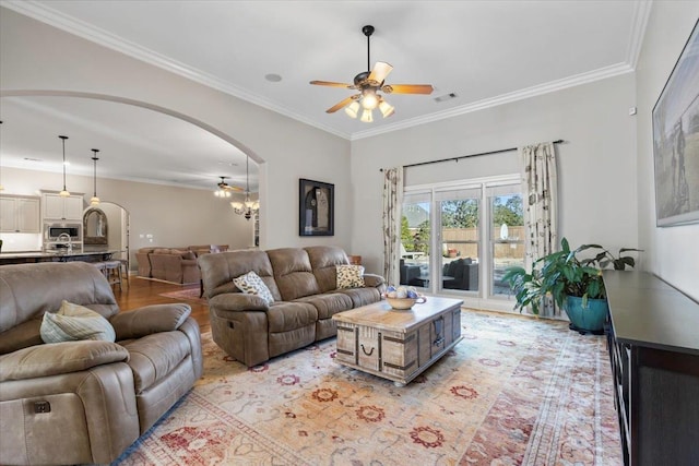 living room featuring ceiling fan and crown molding