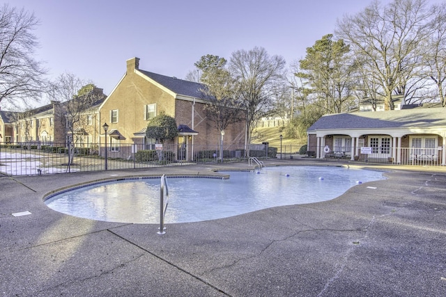 pool at dusk with a patio