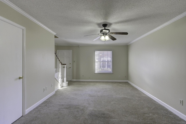 spare room featuring ceiling fan, light colored carpet, a textured ceiling, and ornamental molding