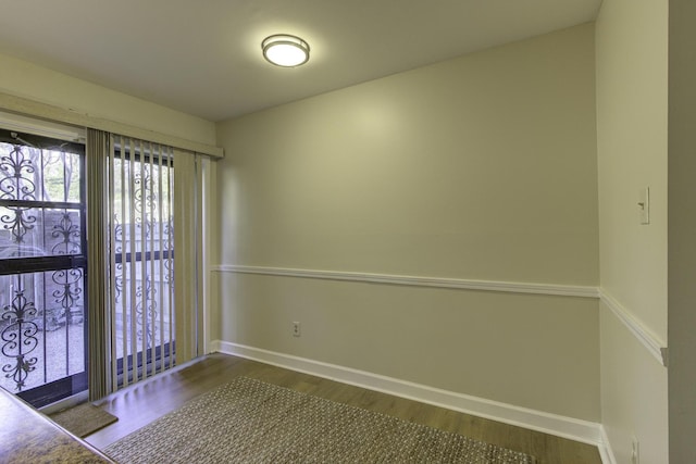 spare room with dark wood-type flooring