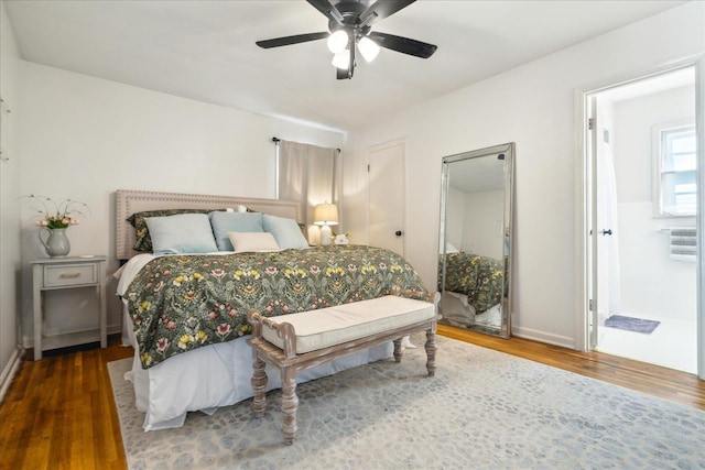 bedroom featuring ceiling fan, dark wood-type flooring, and connected bathroom