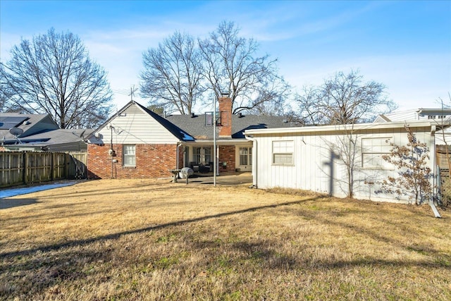 rear view of property with a yard