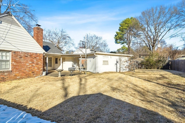 rear view of property with a yard