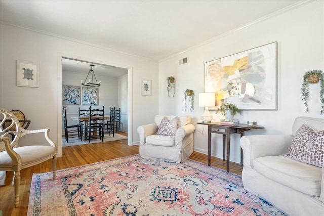 living room with ornamental molding and wood-type flooring