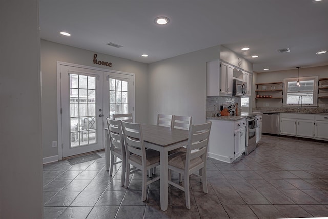 tiled dining space with french doors and sink