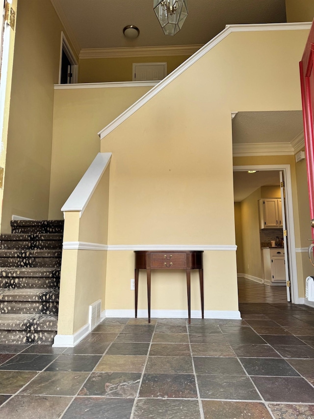 interior space with a chandelier and ornamental molding